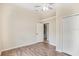 Cozy bedroom with wood floors, a ceiling fan, and closet space, providing a functional and inviting space at 15272 Spinning Wheel Ln, Brooksville, FL 34604