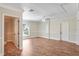Well-lit bedroom featuring wood floors, a ceiling fan, and a doorway to an adjoining bathroom or closet at 15272 Spinning Wheel Ln, Brooksville, FL 34604