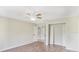 Neutral bedroom featuring wood-look floors, closet, and ensuite bathroom at 15272 Spinning Wheel Ln, Brooksville, FL 34604