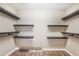 Walk-in closet with dark wood shelving and wood floors at 15272 Spinning Wheel Ln, Brooksville, FL 34604
