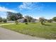 Well-maintained home with a large front yard, mature trees, and long driveway at 15272 Spinning Wheel Ln, Brooksville, FL 34604