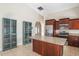 Kitchen featuring a center island with granite countertop adjacent to blue display cabinets at 15272 Spinning Wheel Ln, Brooksville, FL 34604