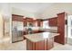 Well-equipped kitchen with stainless steel appliances, a granite island, and plenty of storage space at 15272 Spinning Wheel Ln, Brooksville, FL 34604