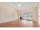 Spacious living room with sliding glass doors that lead to a screened-in pool at 15272 Spinning Wheel Ln, Brooksville, FL 34604