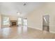 Bright living room with a stone fireplace, tiled flooring, and natural light from the windows at 15272 Spinning Wheel Ln, Brooksville, FL 34604