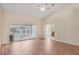 Large living room with access to screened-in pool and ensuite bathroom at 15272 Spinning Wheel Ln, Brooksville, FL 34604