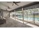 Enclosed patio featuring fans and a view of the pool area at 15272 Spinning Wheel Ln, Brooksville, FL 34604