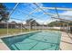 The refreshing screened-in pool features a bright blue liner and is surrounded by an open-air frame at 15272 Spinning Wheel Ln, Brooksville, FL 34604