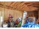 Interior view of shed shows wooden support framing and assorted tools, gear, and play items at 15272 Spinning Wheel Ln, Brooksville, FL 34604