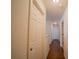 Bright hallway with wood-look floors and neutral walls at 1708 Abbey Trace Dr, Dover, FL 33527