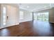 Bright living room with dark hardwood floors and sliding glass doors at 29456 Velletri Ln, Wesley Chapel, FL 33543