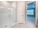 Clean bathroom with a glass shower and a linen closet at 29456 Velletri Ln, Wesley Chapel, FL 33543