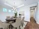 Elegant dining room with hardwood floors and a modern chandelier at 29456 Velletri Ln, Wesley Chapel, FL 33543