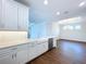 Modern kitchen with white cabinets, quartz countertops, and breakfast bar at 29456 Velletri Ln, Wesley Chapel, FL 33543