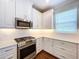 Well-equipped kitchen with white cabinetry and stainless steel appliances at 29456 Velletri Ln, Wesley Chapel, FL 33543