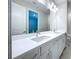 Elegant bathroom with double sinks, quartz countertop, and modern lighting at 29456 Velletri Ln, Wesley Chapel, FL 33543