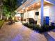 Inviting covered patio with comfortable seating, ceiling fans, outdoor lighting, and a built-in grill, perfect for entertaining at 3106 W Bay Villa Ave, Tampa, FL 33611