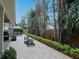 Spacious backyard featuring a charming fire pit area, complemented by lush landscaping and pavers at 3106 W Bay Villa Ave, Tampa, FL 33611