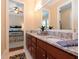 Bathroom with double vanity, granite countertop, and a view of the bedroom at 3106 W Bay Villa Ave, Tampa, FL 33611