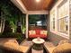 Inviting covered patio with comfortable seating, lush greenery, and tranquil ambiance perfect for outdoor relaxation at 3106 W Bay Villa Ave, Tampa, FL 33611