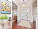 Bright foyer with white trim, light hardwood floors, and view to a sitting area at 3106 W Bay Villa Ave, Tampa, FL 33611