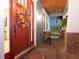 Inviting covered front porch with brick flooring, comfortable seating, and a charming front door with seasonal wreath at 3106 W Bay Villa Ave, Tampa, FL 33611