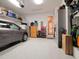 This garage features an epoxy floor, storage, and access to interior rooms at 3106 W Bay Villa Ave, Tampa, FL 33611