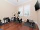 Home gym boasts hardwood floors, natural light, and includes exercise equipment at 3106 W Bay Villa Ave, Tampa, FL 33611