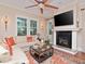 Bright living room with a fireplace, large windows, and hardwood floors, creating a cozy and elegant atmosphere at 3106 W Bay Villa Ave, Tampa, FL 33611