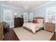Serene main bedroom with soft blue walls, hardwood floors, a chandelier, and two large windows with plantation shutters at 3106 W Bay Villa Ave, Tampa, FL 33611