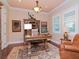 Inviting home office with a large desk, built-in shelves, hardwood floors, and natural light at 3106 W Bay Villa Ave, Tampa, FL 33611