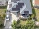 Aerial view of house with solar panels, driveway, and lush landscaping at 3925 1St Ne St, St Petersburg, FL 33703