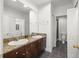 Bathroom with double sinks, granite counters, and a walk-in shower at 403 S Oregon Ave, Tampa, FL 33606