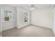 Serene bedroom with neutral walls, carpet flooring, and natural light from two shuttered windows at 403 S Oregon Ave, Tampa, FL 33606