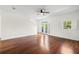 Spacious bedroom with wood floors, ceiling fan, white walls, balcony and window with shutters at 403 S Oregon Ave, Tampa, FL 33606