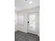 Bright entryway featuring tile floors, a shuttered window, and a white door with stylish hardware at 403 S Oregon Ave, Tampa, FL 33606