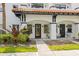 Close-up of a townhouse exterior with a distinctive red tile roof and lush greenery at 403 S Oregon Ave, Tampa, FL 33606