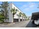 Exterior view of the white townhome garages with palm trees at 403 S Oregon Ave, Tampa, FL 33606