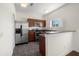 Well-lit kitchen featuring stainless steel appliances, granite countertops, and ample cabinet space at 403 S Oregon Ave, Tampa, FL 33606