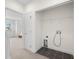 The upstairs laundry closet features tile floors and a wall-mounted wire shelf for convenience at 403 S Oregon Ave, Tampa, FL 33606