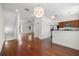 Spacious living area with hardwood floors, a staircase, and an open kitchen with modern appliances at 403 S Oregon Ave, Tampa, FL 33606