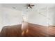 Spacious living room with wood floors, ceiling fan, white walls, and staircase to the second floor at 403 S Oregon Ave, Tampa, FL 33606