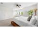 Bright main bedroom featuring a ceiling fan and multiple windows with plantation shutters at 403 S Oregon Ave, Tampa, FL 33606