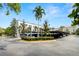 Exterior view of the condo building's parking and landscaping on a sunny day at 403 S Oregon Ave, Tampa, FL 33606
