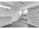 Elegant bathroom with gray tile and white cabinets at 452 Bath Club N Blvd, North Redington Beach, FL 33708