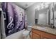 Bathroom with music-themed shower curtain and granite vanity at 5923 Tealwater Pl, Lithia, FL 33547