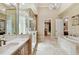Bathroom with a large soaking tub, walk in shower and and vanities at 602 Guisando De Avila, Tampa, FL 33613