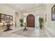 Elegant entryway with a large wooden door and high ceilings at 602 Guisando De Avila, Tampa, FL 33613