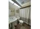 Clean bathroom with shower, toilet, and pedestal sink at 1309 Peachfield Dr, Valrico, FL 33596