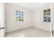 Simple bedroom with tile flooring and two windows at 1512 Hillside Dr, Tampa, FL 33610